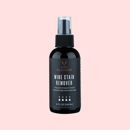 Black wine stain remover spray bottle with visible branding on a white background