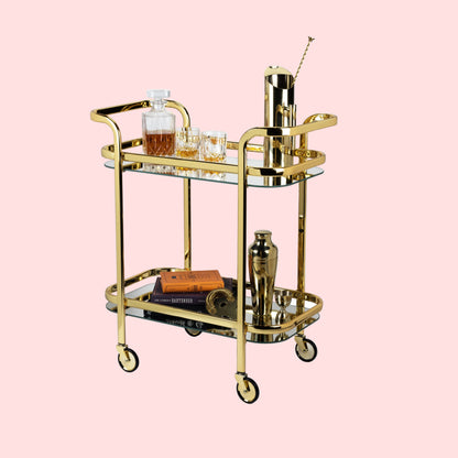 Gold bar cart with drinks and accessories on a white background