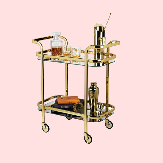 Gold bar cart with drinks and accessories on a white background
