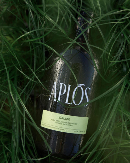 aplos calme bottle laying on grass